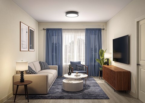 A modern living room with a sofa, coffee table, and a television.