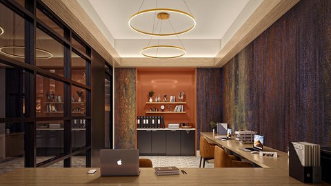 A modern office space with a laptop on the desk.