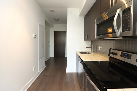 A modern kitchen with a black stove top oven.