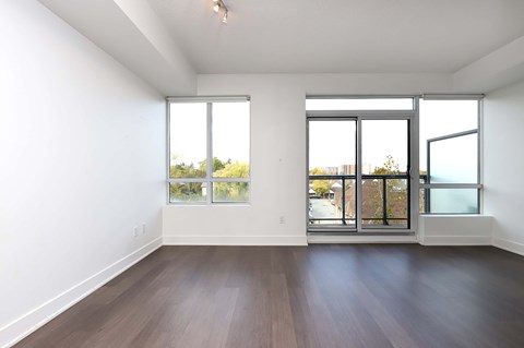 A room with a sliding glass door and a window.