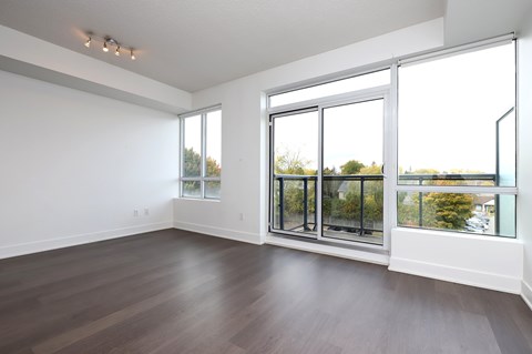 A large empty room with a sliding glass door.