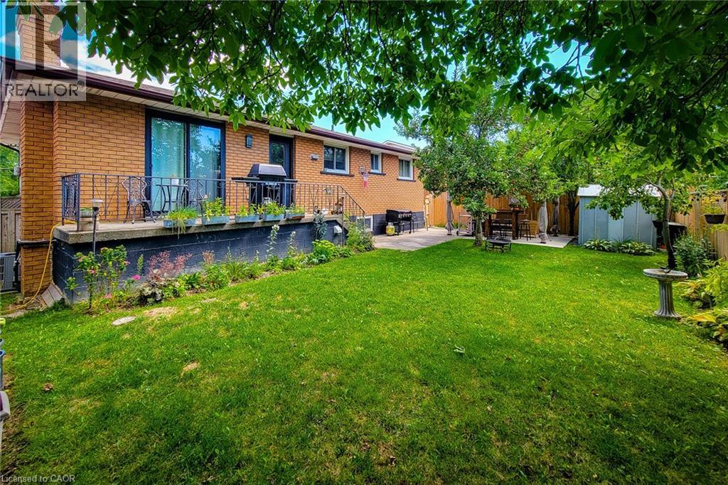 A backyard with a lawn and a patio area.