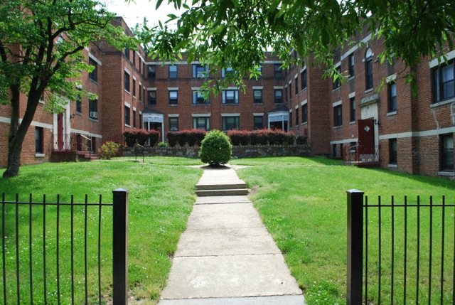 a sidewalk in front of an apartment building