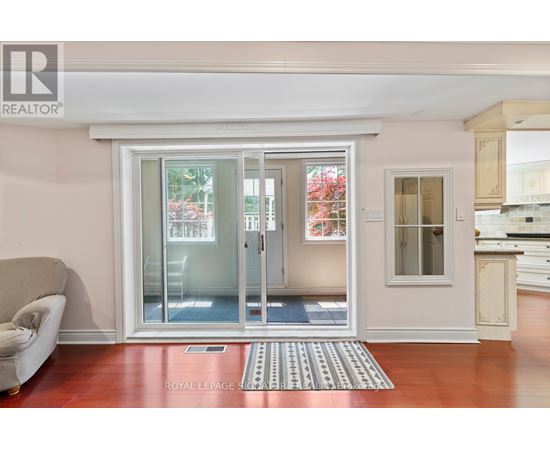 A living room with a couch and a sliding glass door.