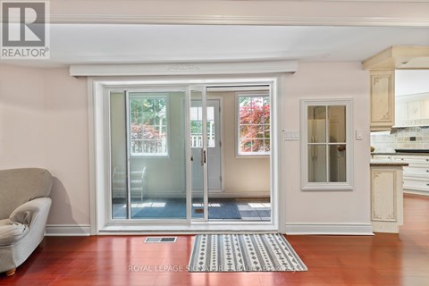A living room with a couch and a sliding glass door.