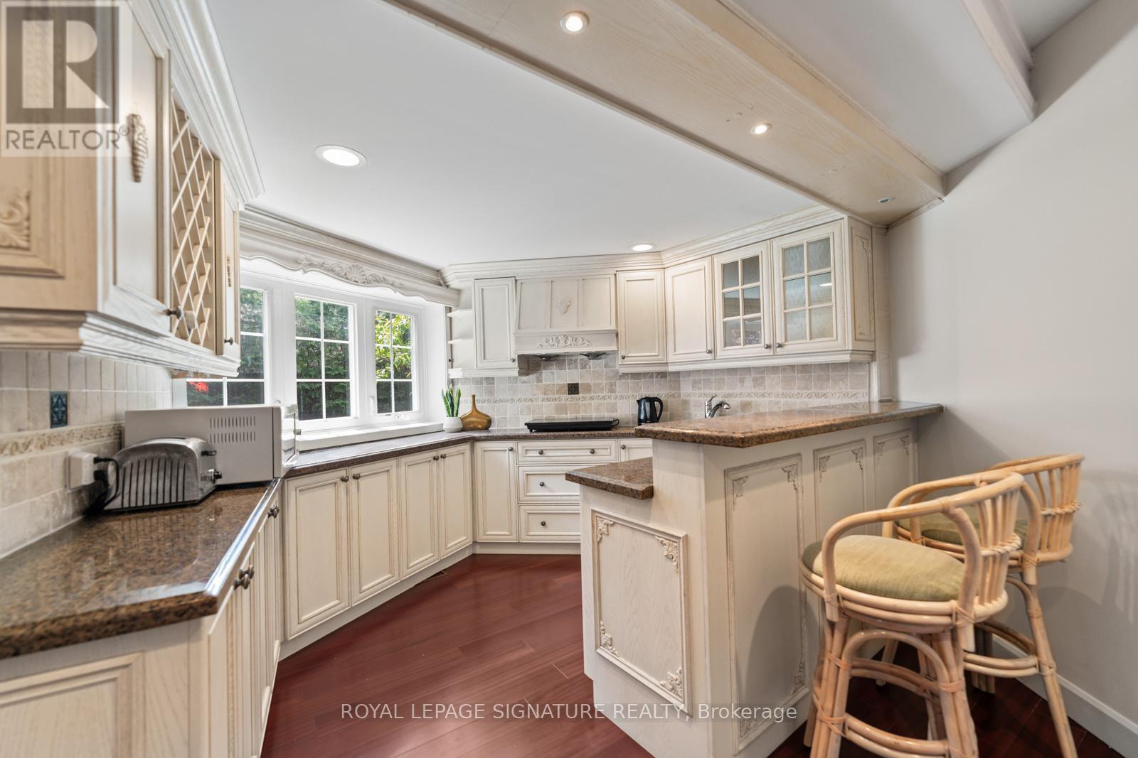 A kitchen with wooden cabinets and a granite countertop.