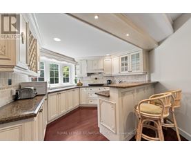 A kitchen with wooden cabinets and a granite countertop.
