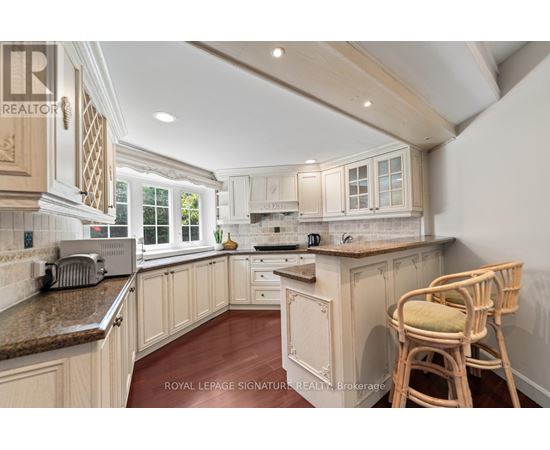 A kitchen with wooden cabinets and a granite countertop.