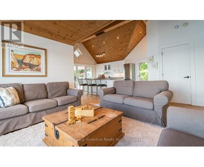 A living room with a wooden coffee table and grey couches.