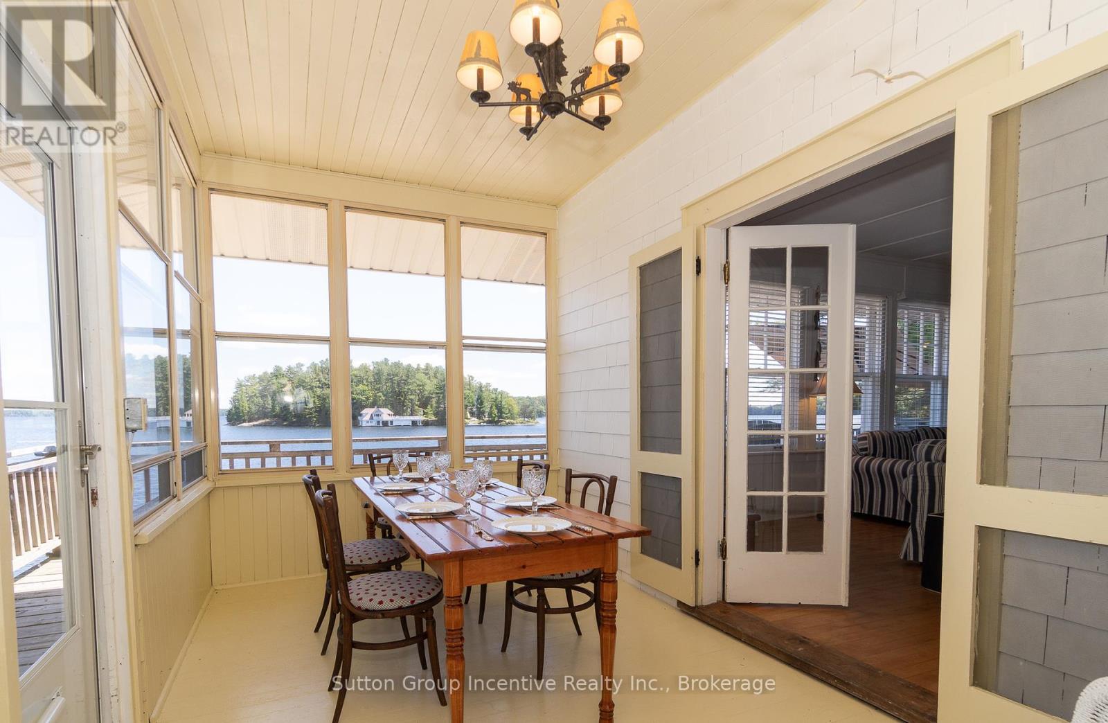 A dining room with a table set for a meal.