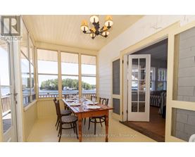 A dining room with a table set for a meal.