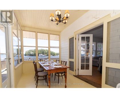 A dining room with a table set for a meal.