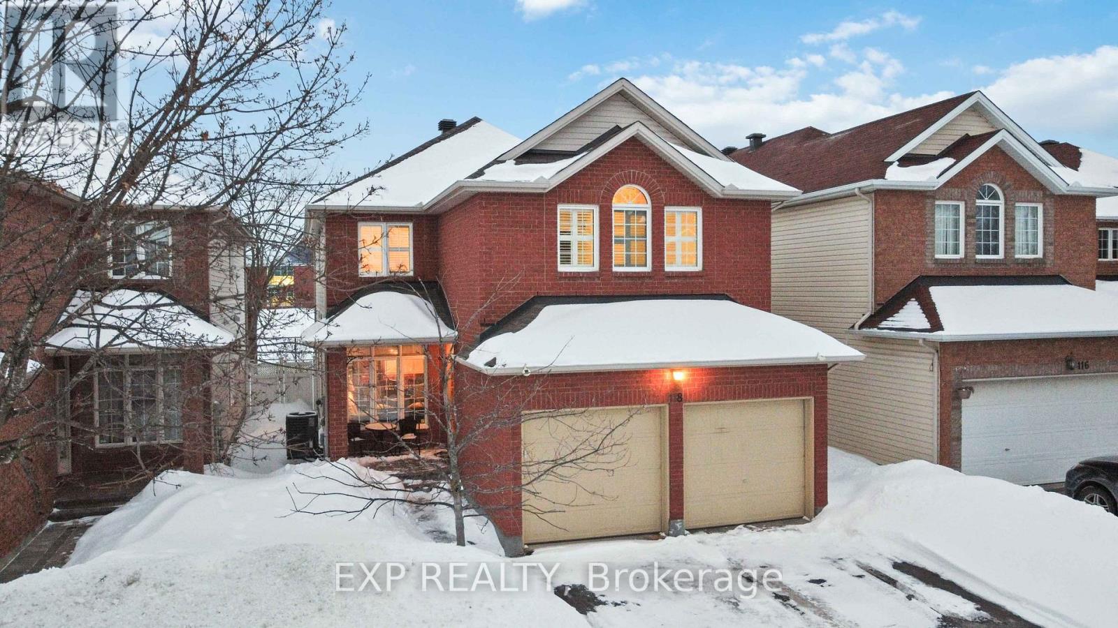 A house with a snow-covered front yard.