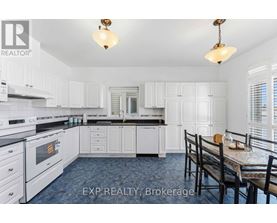 A kitchen with white cabinets and a blue counter.
