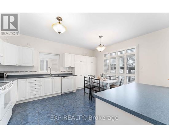 A kitchen with white cabinets and a blue counter.