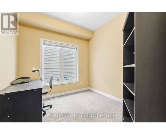 A bedroom with a large bed and a carpeted floor.