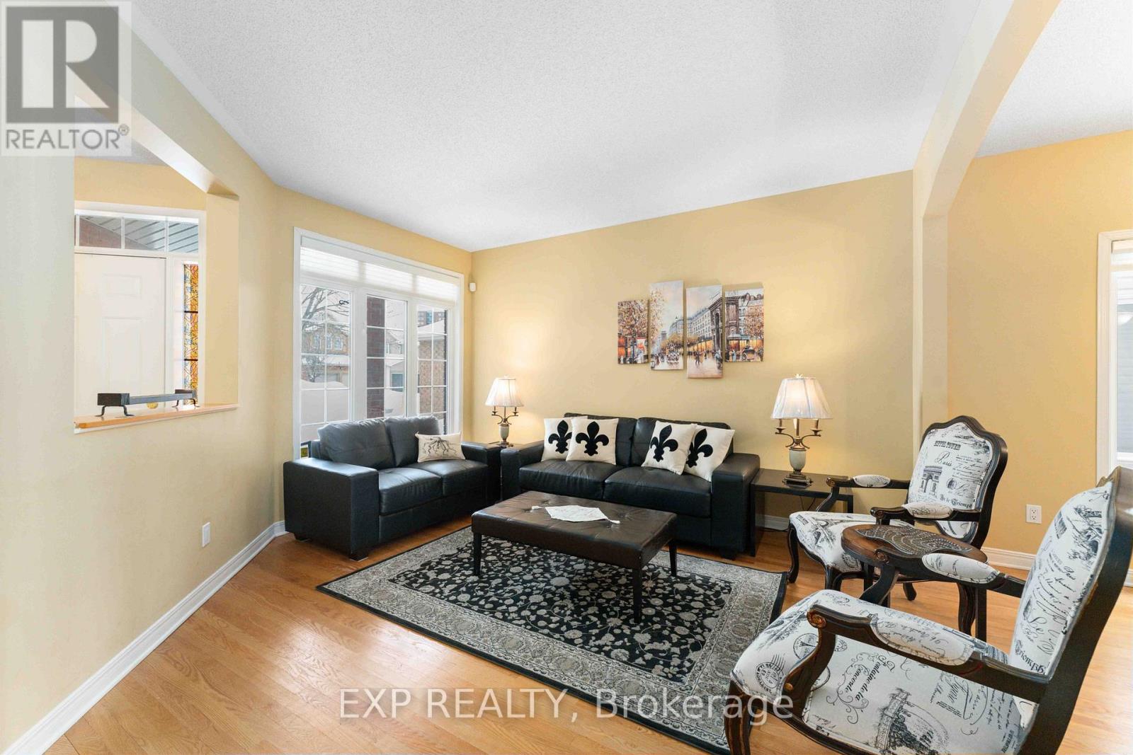 A living room with a black couch and a coffee table.