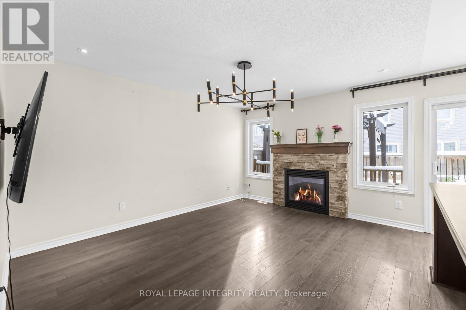 A living room with a fireplace and a television.