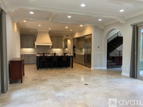 A spacious kitchen with a dining table set for four.