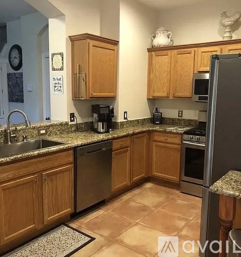 A kitchen with wooden cabinets and granite countertops.