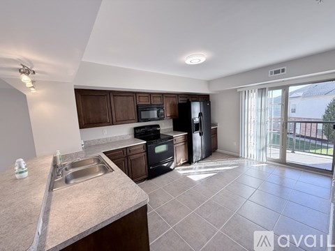A kitchen with brown cabinets and a granite countertop.
