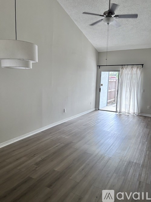 A room with a ceiling fan and a light fixture.