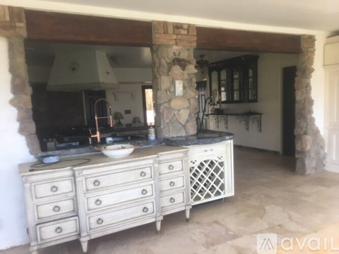 A kitchen with a stone pillar and a stone countertop.