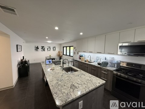 A kitchen with granite countertops and modern appliances.
