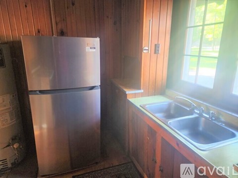 A kitchen with a stainless steel refrigerator and a sink.
