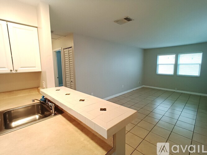 A kitchen with a sink and cabinets.