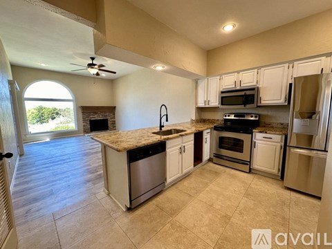 A kitchen with a large island and stainless steel appliances.