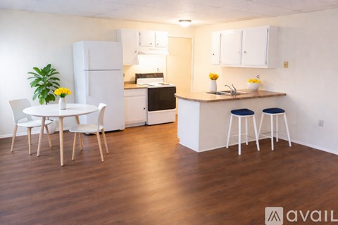 A kitchen with black appliances and white cabinets.