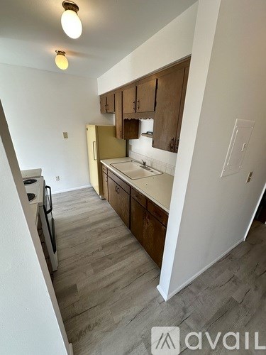 A kitchen with wooden cabinets and a white countertop.