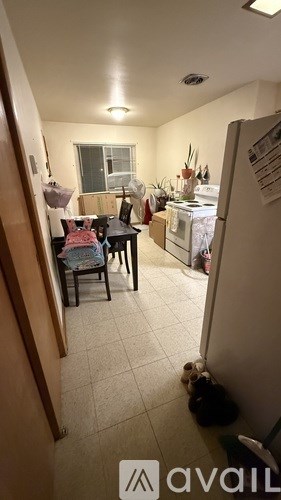 A kitchen area with a table and chairs.