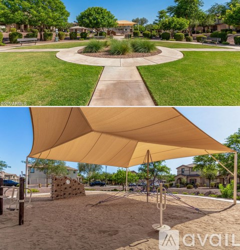 A playground with a sandbox and a shaded area.