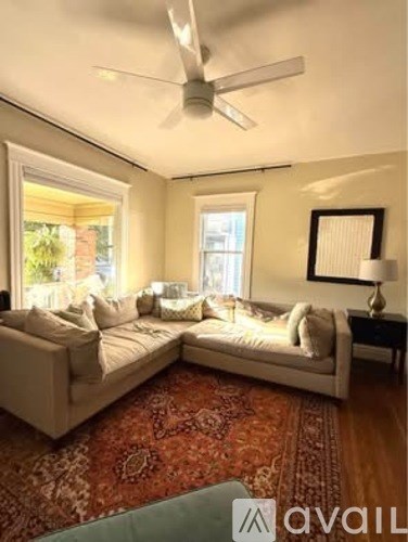 A living room with a rug and a couch.