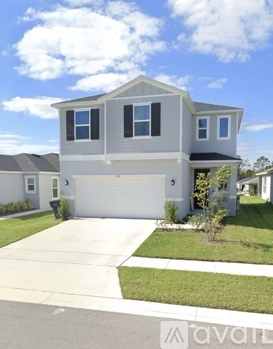 A two-story house with a garage and a driveway.
