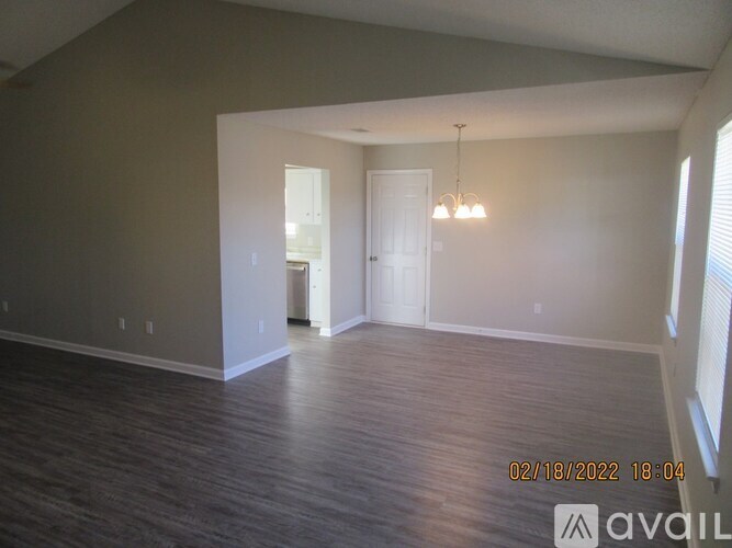 A room with wooden floors and a white door.