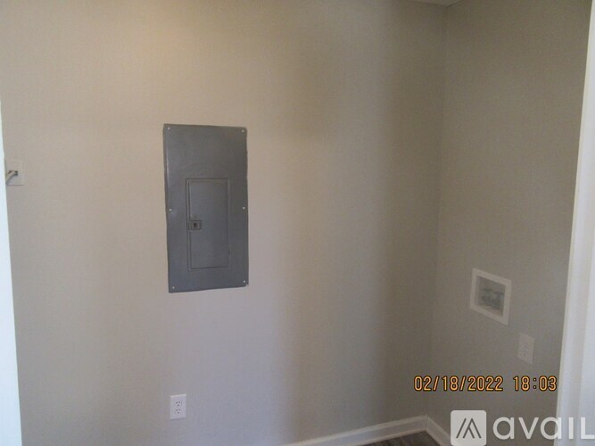 A wall with a switch and a socket on it.