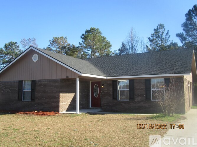 A house with a brown roof and a red door is available for purchase.