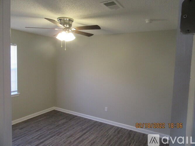 A room with a ceiling fan and a window.