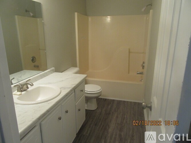 A bathroom with a toilet, sink, and shower.