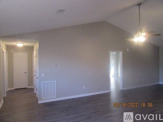 A room with a ceiling fan and a light fixture.