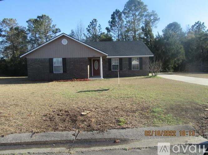 A house with a brown roof and a red door is for sale.