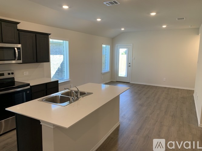 A kitchen with a white countertop and black cabinets.