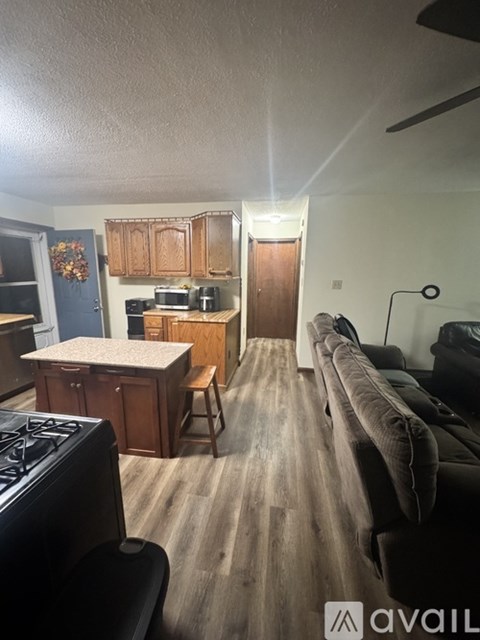 A kitchen with a stove top oven and a counter top.