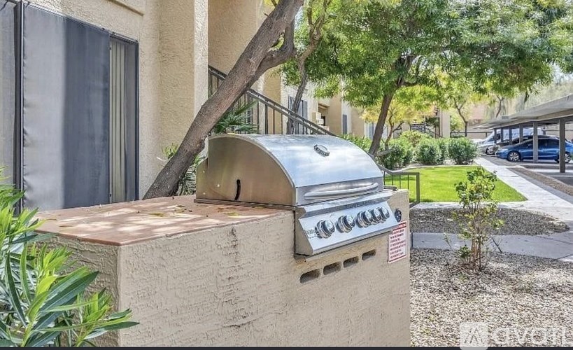 A grill is attached to the side of a house.