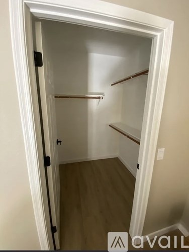 A white door with a black handle and a small window in the middle.