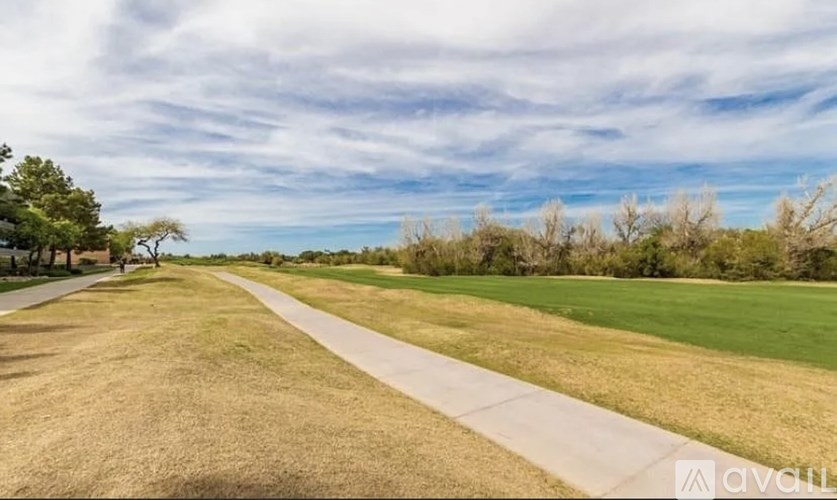 A long, straight pathway leads through a grassy field.