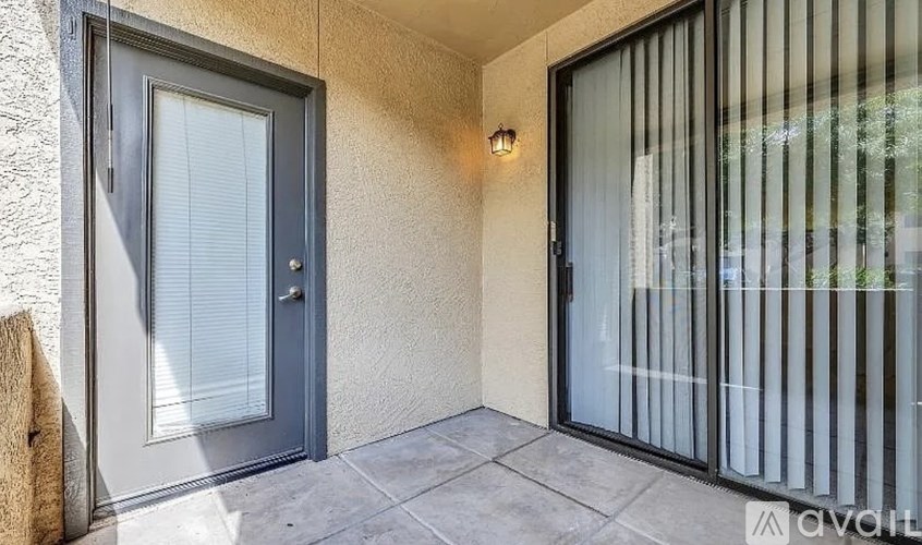 A modern house entrance with a glass door and a wooden post.